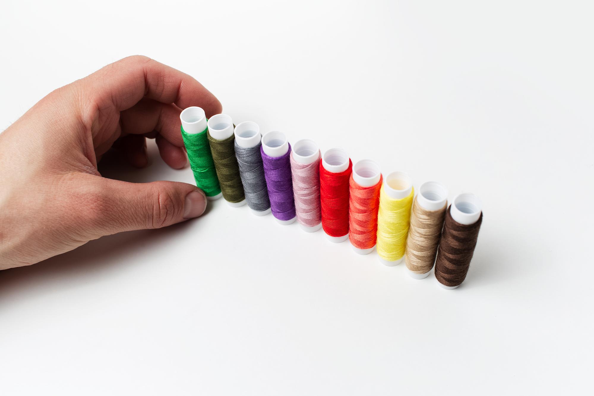 close-up of hands preparing embroidery thread